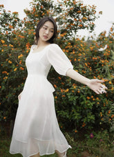 Midi organza dress with puff sleeves and scoop neckline for an ethereal feminine silhouette